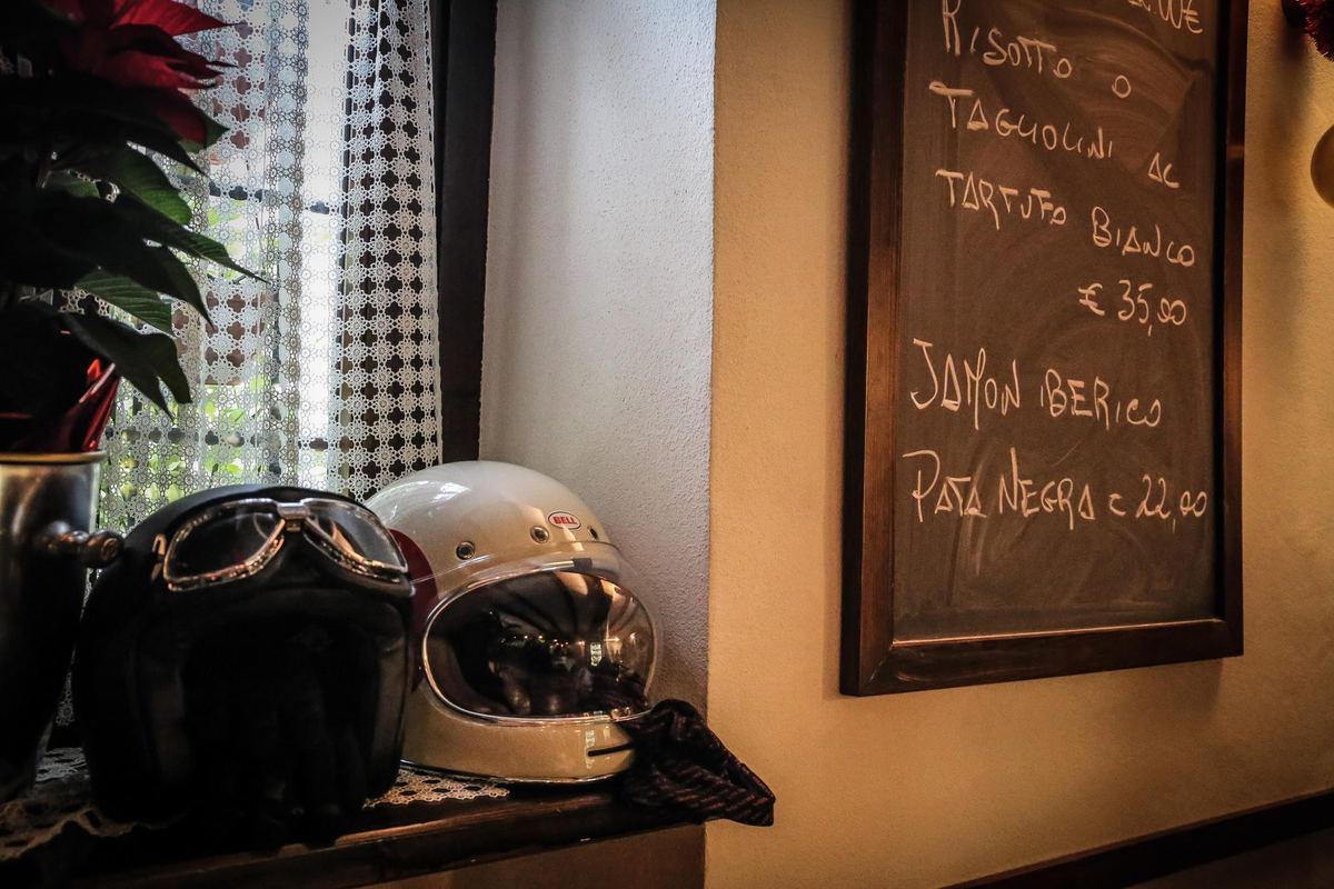 Caschi sul tavolo e la lavagna del menu alla sosta per il pranzo